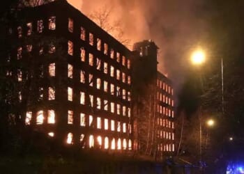 Inferno rips through historic building as homes evacuated and fire crews battle blaze saying 'completely avoid area'