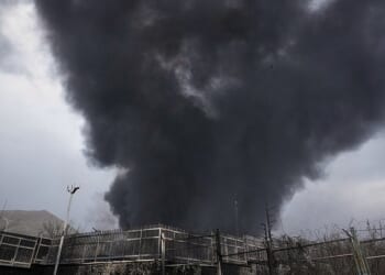 A thick plume of smoke rises from an oil storage facility hit by a US-Israeli strike late Saturday in Tehran, Iran, Sunday, March 8, 2026