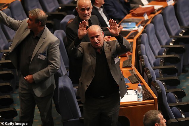 Taj (pictured, centre) even compared the granting of asylum to team members to the bombing of a school in Iran that killed 168 people at the start of the current war in the Middle East