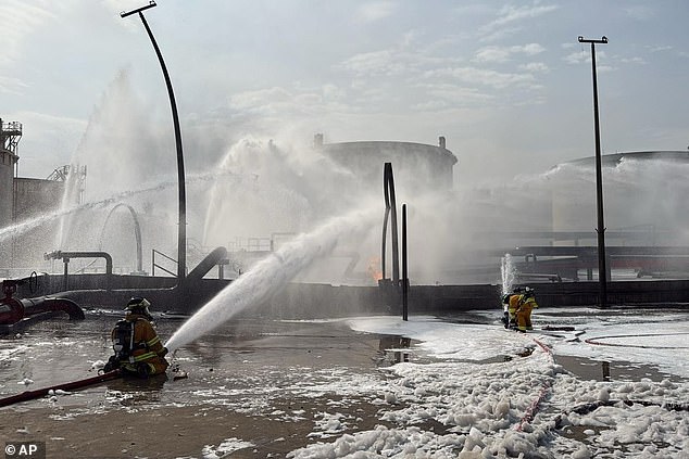 Firefighters extinguishing flames after an Iranian projectile struck an industrial area in Ma'ameer, Bahrain on March 9 2026
