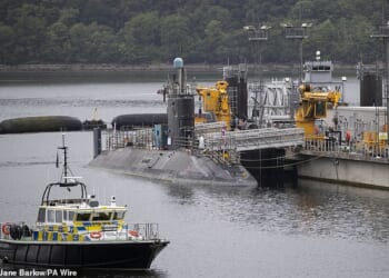 An Iranian man, 34, and a Romanian woman, 31, have been charged after attempting to enter Britain's Faslane nuclear naval base