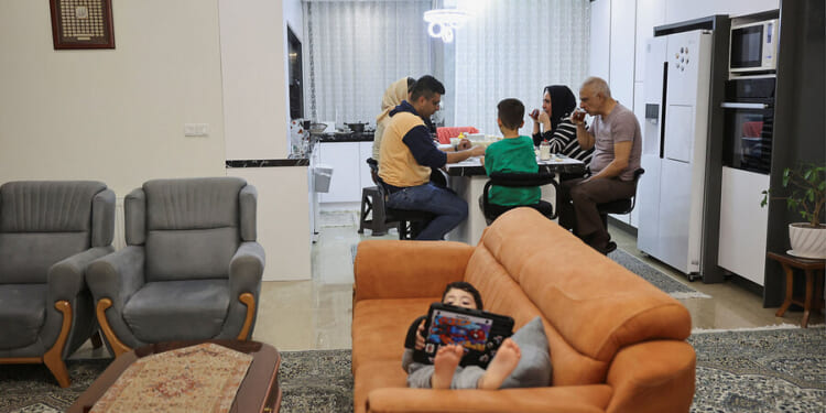 Iranians caught between unremitting attack, unyielding regime