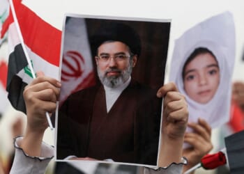 A schoolgirl holds up a poster of Iran's new supreme leader Mojtaba Khamenei during an anti-U.S. and Israel demonstration in Baghdad on March 12, 2026.