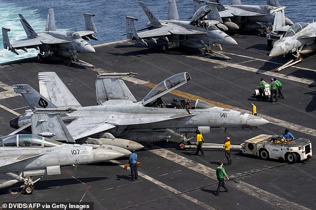 An F/A-18F Super Hornet, attached to Strike Fighter Squadron (VFA) 41, taxies on the flight deck aboard Nimitz-class aircraft carrier USS Abraham Lincoln (CVN 72) on Wednesday