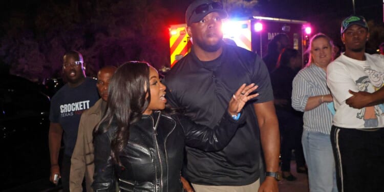 Rep. Jasmine Crockett, a Texas Democrat, is seen Feb. 27 with the security team member she said she knew as Mike King, but who was later identified as 39-year-old Diamon-Mazairre Robinson. Robinson was shot and killed March 11 in a standoff with Dallas police.