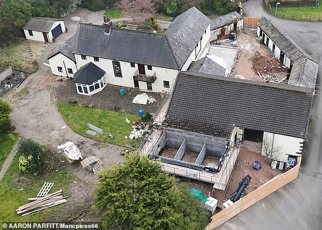 The sprawling four-bedroom property features a gated cobbled driveway, 16 stables, and a large barn, set over 15 acres of land