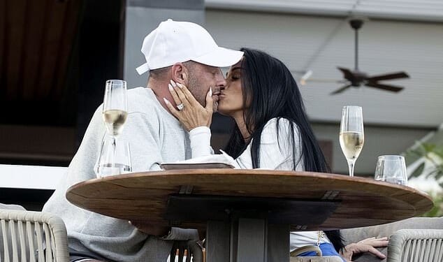 Katie Price and husband Lee Andrews showed off the results of their cosmetic procedures while packing on the PDA in war-torn Dubai on Friday