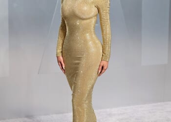 Kim Kardashian struggled to walk in a skintight golden gown and towering 'stripper heels' as she attended the star-studded Vanity Fair Oscars party on Sunday