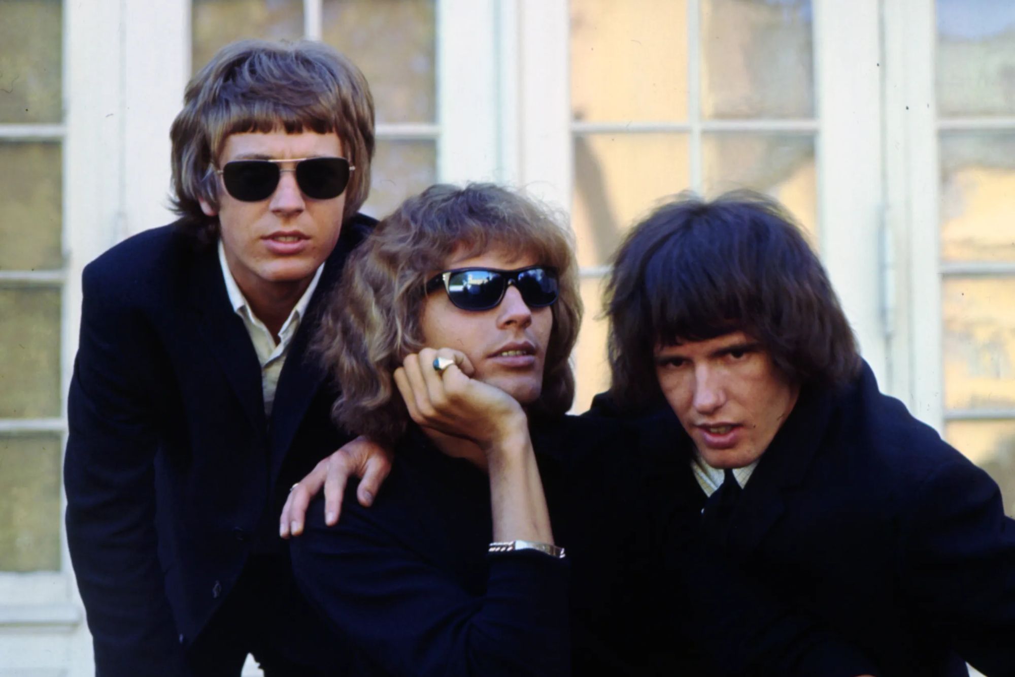 An image collage containing 1 images, Image 1 shows The Walker Brothers band members pose for a photo, one seated and two standing