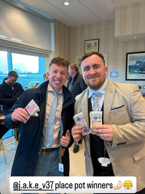 Two men smiling and holding bundles of cash.