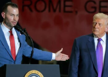 President Donald Trump, right, looks on Republican congressional candidate Clay Fuller speaks at the Coosa Steel Corporation in Rome, Georgia, on Feb. 19. Trump endorsed Fuller to replace the seat vacated by former Rep. Marjorie Taylor Greene.