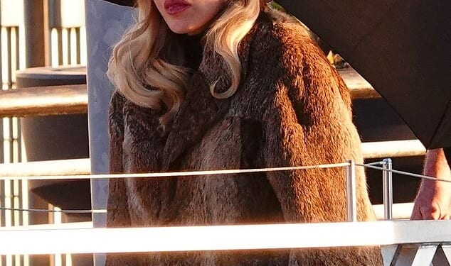 Madonna wrapped up in a brown fur coat as she stepped out in Venice with her boyfriend Akeem Morris on Friday