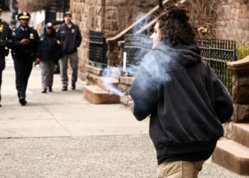A violent leftist holds a homemade explosive device before throwing it into a right-wing anti-"Islamification" protest outside Mayor Zohran Mamdani's mansion in New York on March 7, 2026.