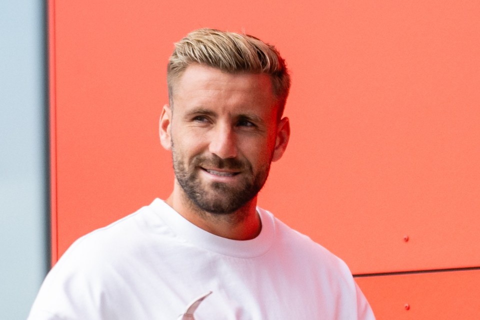 Luke Shaw smiling at Carrington Training Ground.