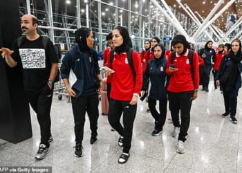Pictured: Iranian team members arriving at Kuala Lumpur Airport on their way back to Iran, where they face possible severe reprisals for their anthem boycott