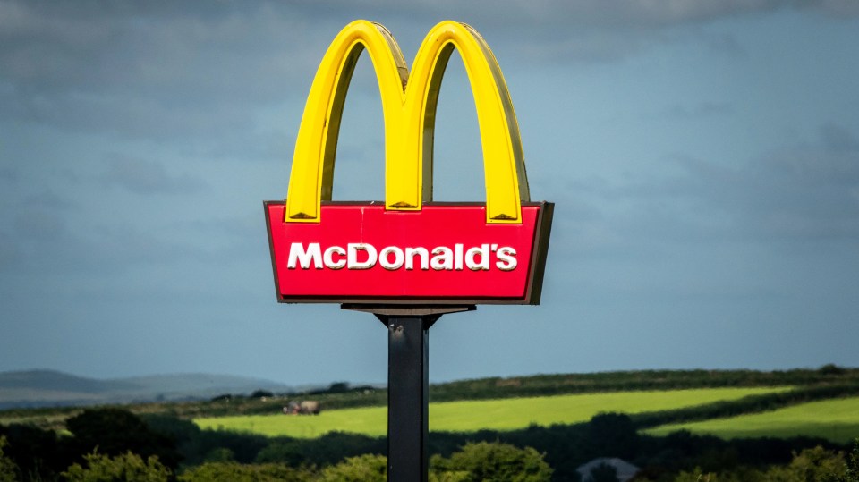 McDonald's sign featuring the yellow Golden Arches logo with the name "McDonald's" written in white on a red background.
