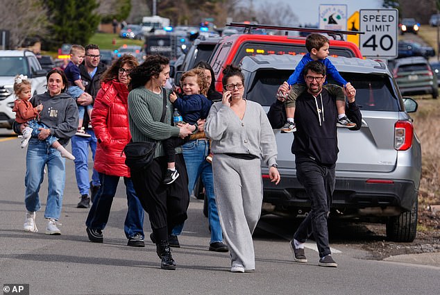 Parents and children outside Temple Israel synagogue, which has an early childhood center, in West Bloomfield Township, after the gunman opened fire