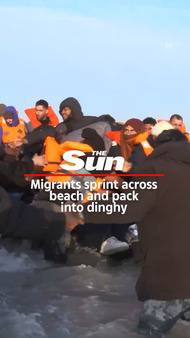 Migrants sprint across beach and pack  into dinghy