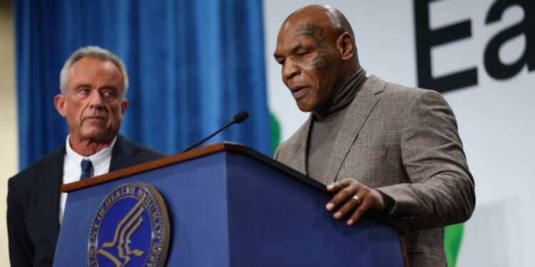 Mike Tyson speaks next to U.S. Secretary of Health and Human Services Robert F. Kennedy Jr. at an event in Washington, DC on Feb. 11, 2026.