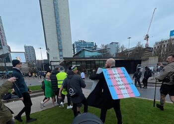 Green Party MP Hannah Spencer was escorted by police through Manchester city centre after a brawl erupted involving anti-transgender protesters (pictured)