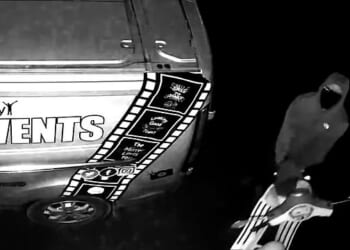 Moment brazen thieves stare directly into camera as they make off with Vespa and two mountain bikes