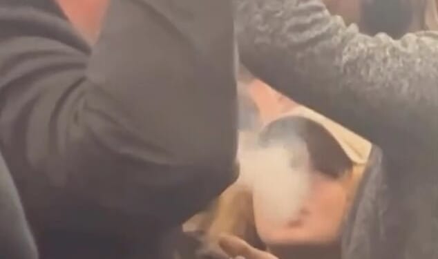 A vaping girl ignores the man's request for her to stop and instead exhales smoke towards him