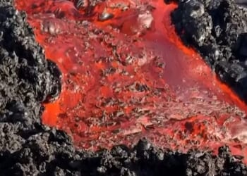 Spectacular footage has captured lava from a volcano on a French island making contact with the ocean for the first time in years