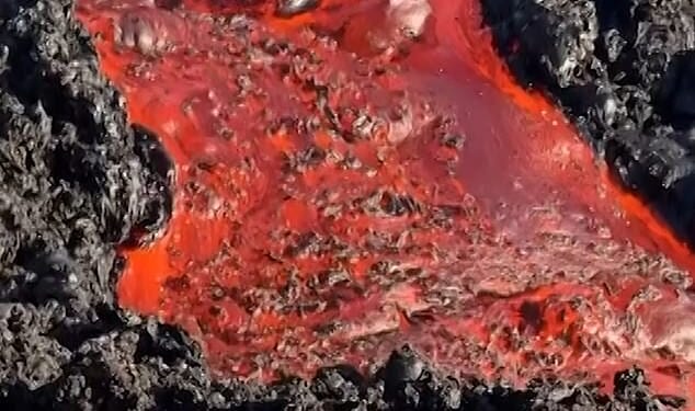 Spectacular footage has captured lava from a volcano on a French island making contact with the ocean for the first time in years