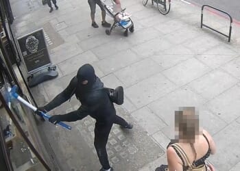 Two thugs wearing balaclavas used sledgehammers to smash their way into a luxury shop on Edgeware Road in Westminster