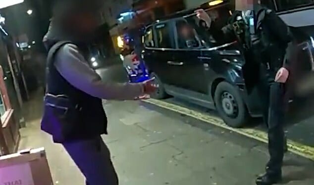 This is the moment (pictured) two brave female police officers confronted a man brandishing a knife, shoving him into a shopfront to take the blade off the streets