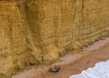 More than 40 students and staff made their way along the narrow beach at West Bay in Dorset which experiences regular rock falls