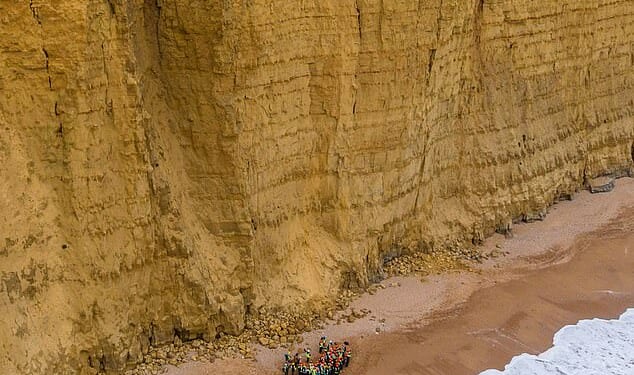 More than 40 students and staff made their way along the narrow beach at West Bay in Dorset which experiences regular rock falls