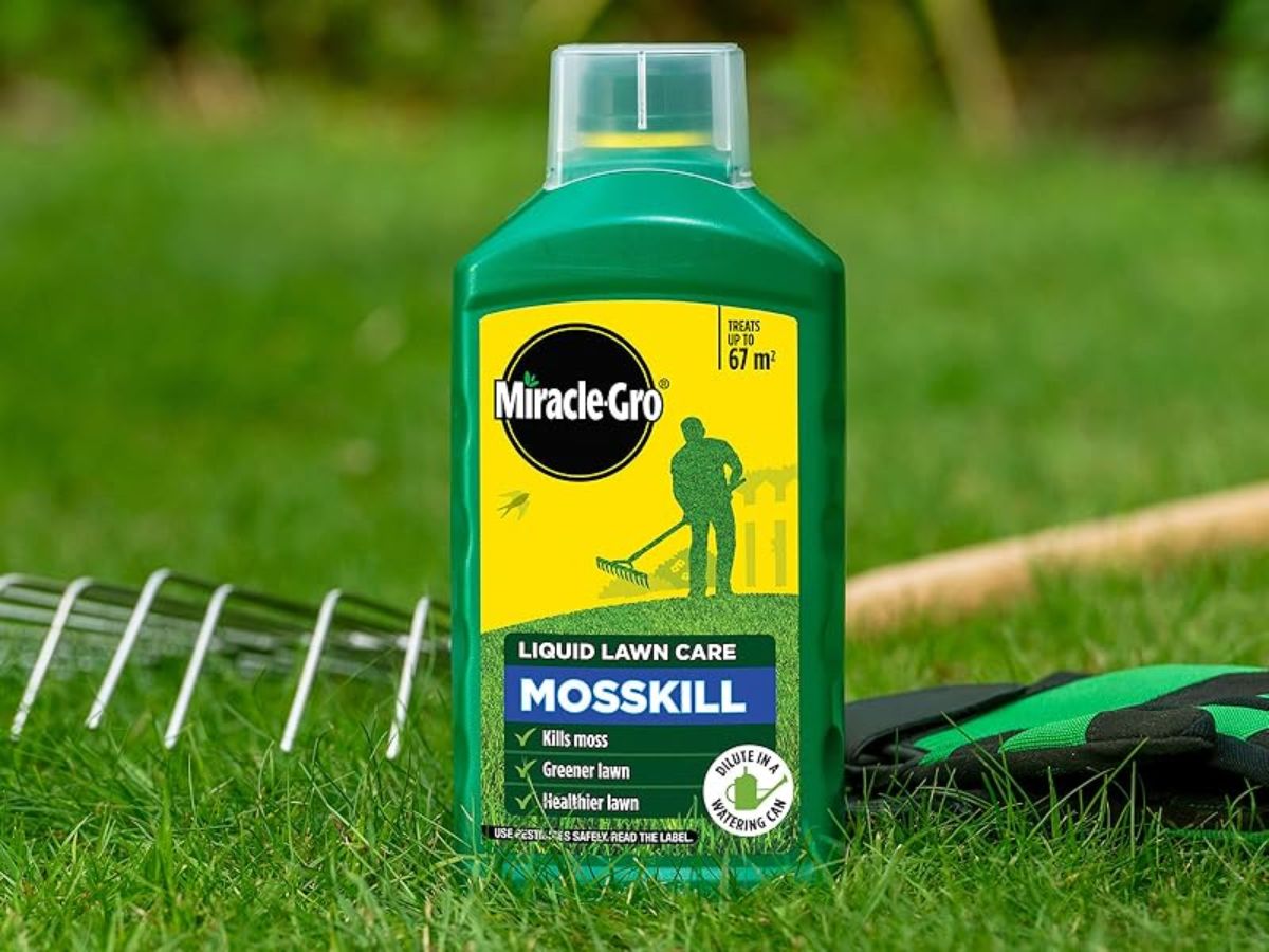 A bottle of Miracle-Gro Liquid Lawn Care Mosskill on a green lawn.