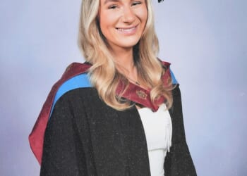 Lucy Harrison pictured at her university graduation with a first class degree in fashion