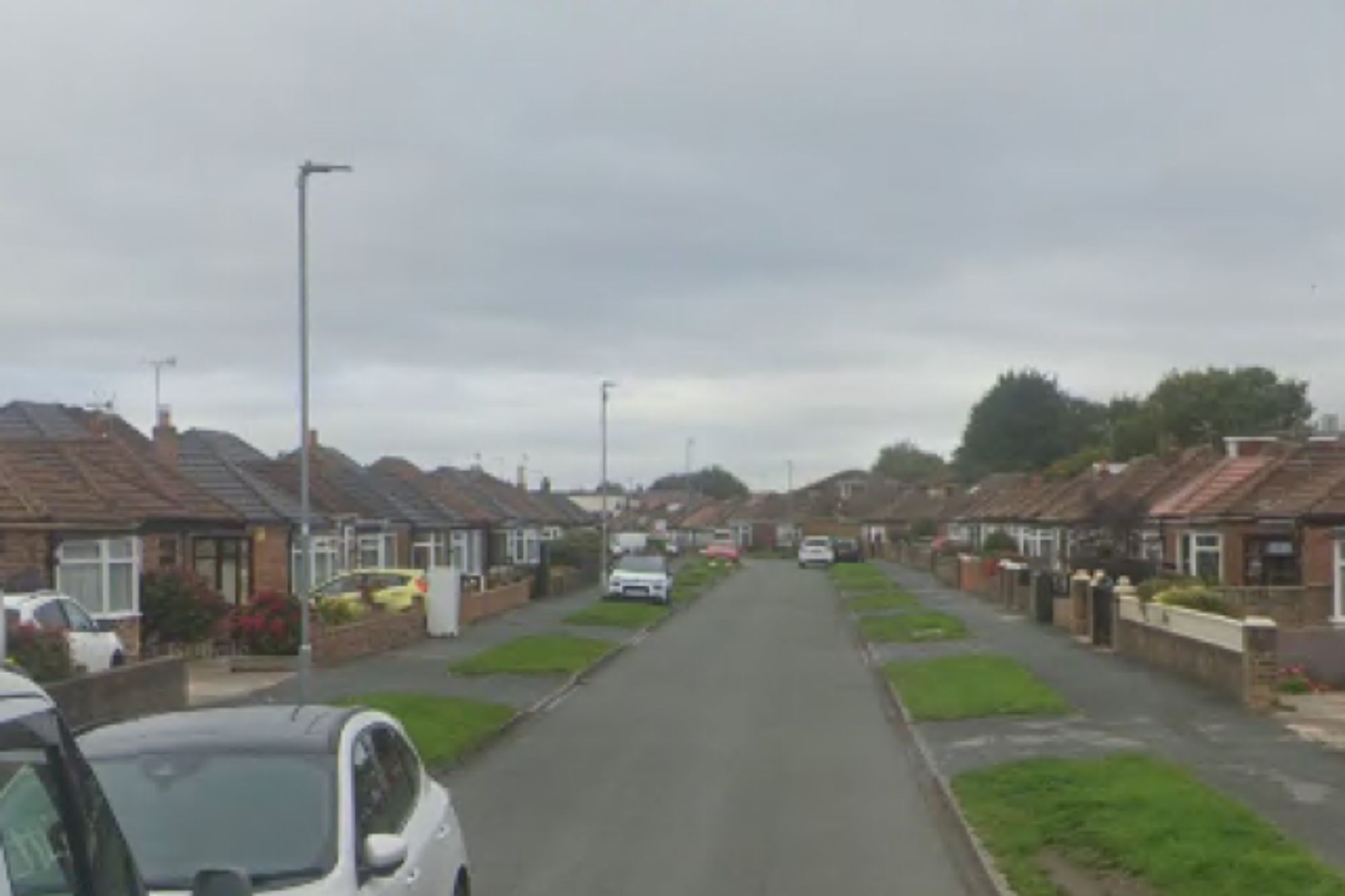 An image collage containing 1 images, Image 1 shows Street view of a residential neighborhood with bungalows lining both sides of the road under a cloudy sky