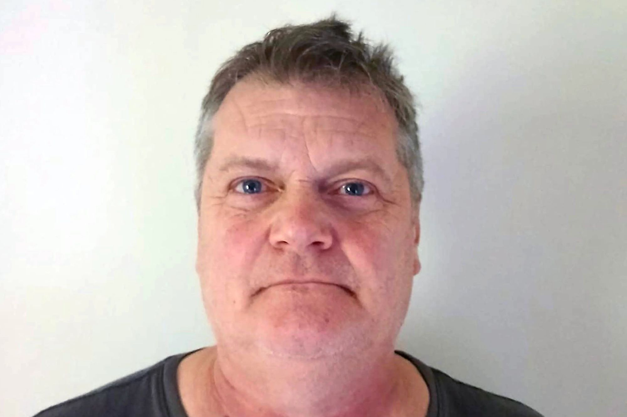 An image collage containing 1 images, Image 1 shows Headshot of a missing British holidaymaker named Michael, a man in his early sixties, with graying hair and a serious expression