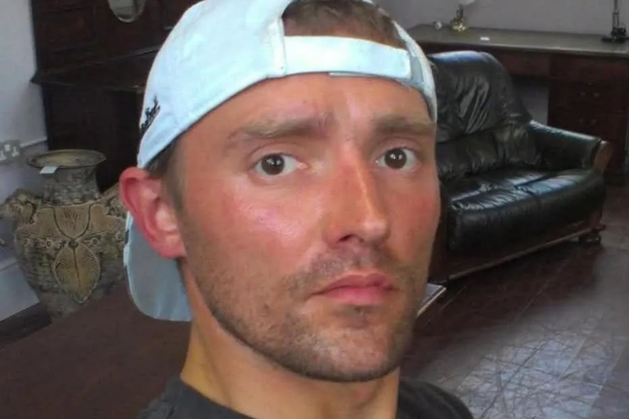 An image collage containing 1 images, Image 1 shows A man with a light blue baseball cap looks directly into the camera