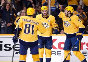 Filip Forsberg, Jonathan Marchessault, and Roman Josi of the Nashville Predators celebrate after a goal during the first period of the game against the San Jose Sharks at Bridgestone Arena on March 24, 2026, in Nashville, Tennessee.