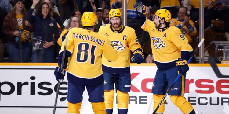 Filip Forsberg, Jonathan Marchessault, and Roman Josi of the Nashville Predators celebrate after a goal during the first period of the game against the San Jose Sharks at Bridgestone Arena on March 24, 2026, in Nashville, Tennessee.