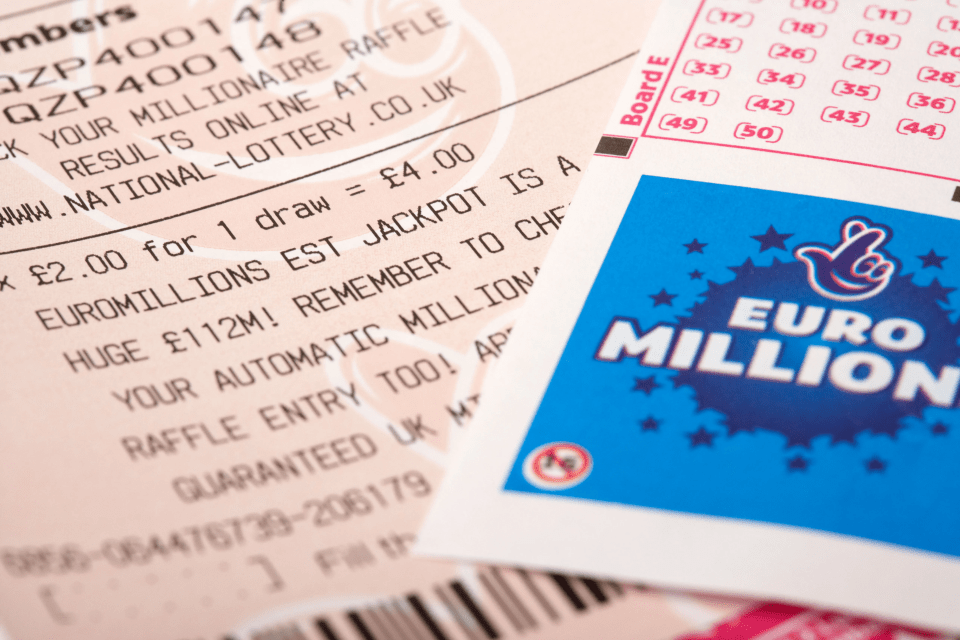 A close-up of a lottery ticket and a EuroMillions card.