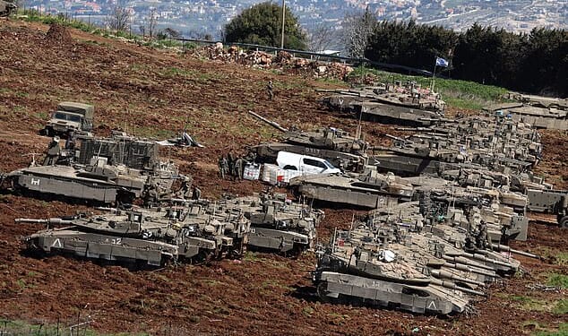 Israel has sent troops into the south of Lebanon as it seeks to destroy Hezbollah. (Pictured: Israeli tanks massing at its northern border with Lebanon)