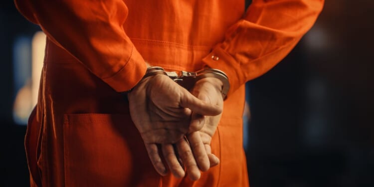 A handcuffed convict before trial.