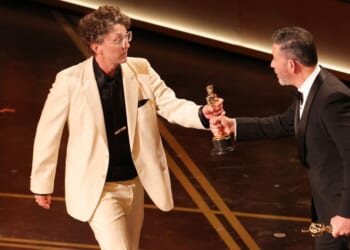David Borenstein, left, accepts the Documentary Feature award from Jimmy Kimmel Sunday for "Mr. Nobody Against Putin" during the 98th Oscars in Hollywood, California. Ratings for the show dropped to the lowest the Oscars have seen in four years.
