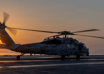 In this handout released by the U.S. Navy, an MH-60S Sea Hawk helicopter, attached to Helicopter Sea Combat Squadron (HSC) 14, lands on the flight deck of the Nimitz-class aircraft carrier USS Abraham Lincoln (CVN 72) in support of Operation Epic Fury on March 2, 2026.