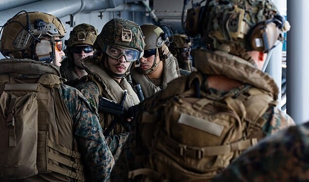 Officials said that the Pentagon is preparing for weeks of ground operations in Iran just shy of a full-scale invasion. Pictured: Sailors and Marine who arrived in the Middle East on Friday