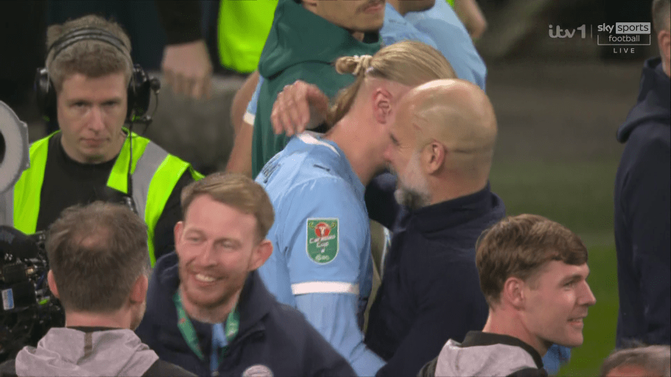 Erling Haaland embracing Pep Guardiola on the field.