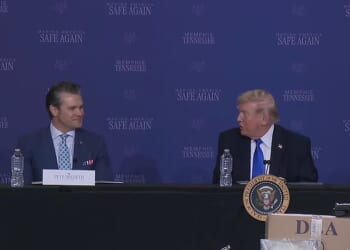 Hegseth forced an awkward smile as the US President continued discussing ongoing talks with Iran