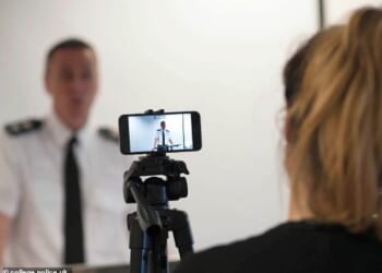 The Policing and Media Charter is being described as the biggest reset in the relationship between policing and the media in decades. Pictured: A police officer is filmed by journalists at a press conference (File image)
