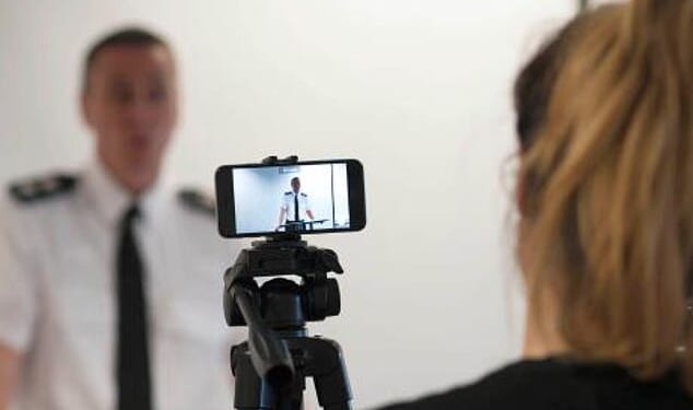 The Policing and Media Charter is being described as the biggest reset in the relationship between policing and the media in decades. Pictured: A police officer is filmed by journalists at a press conference (File image)