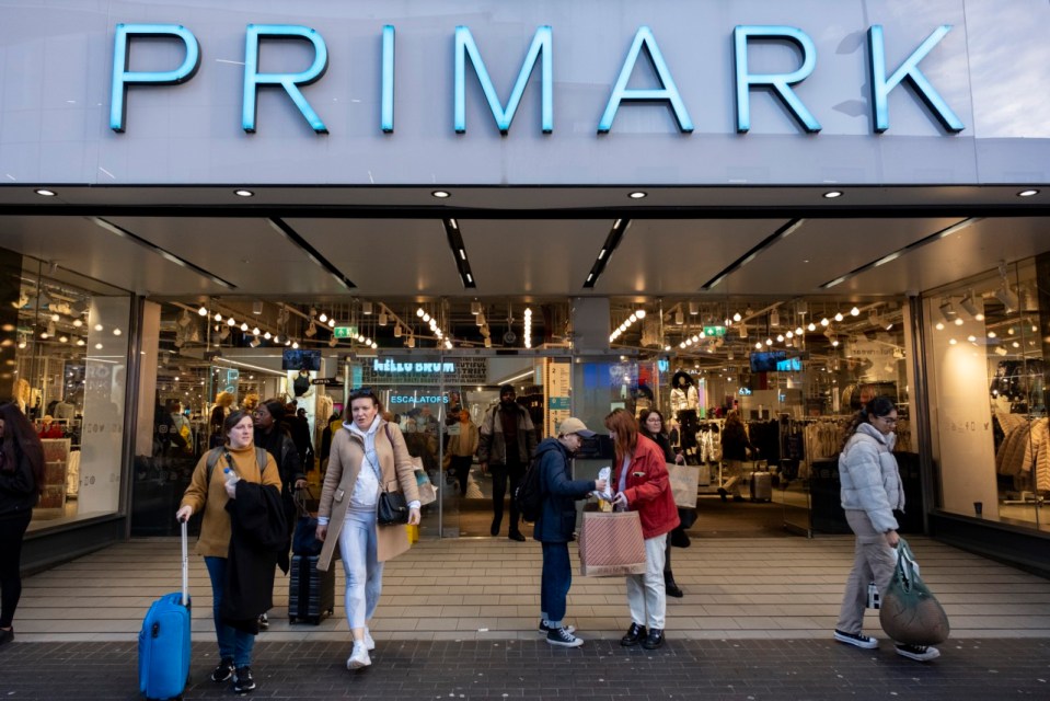 People walking outside a Primark store.